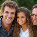 Portrait of a smiling family with two children, clients of Current Capital